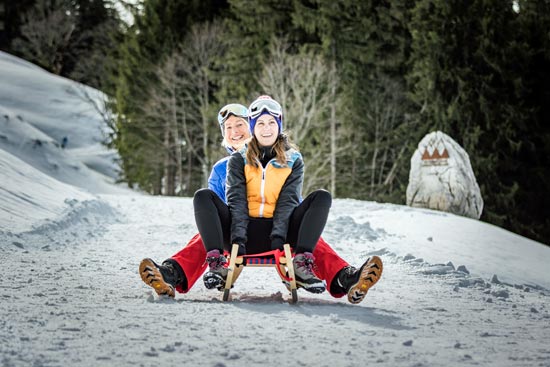Two women sledging in winter Two women sledging in winter