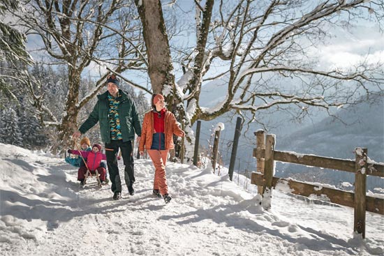 Family on a winter hike along the Soleleitungsweg on a sunny day Family on a winter hike along the Soleleitungsweg on a sunny day