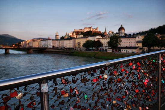 Salzburg in the evening, bridge with many love locks in the foreground Salzburg in the evening, bridge with many love locks in the foreground