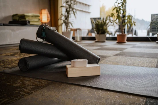 A relaxation room with yoga mats in the foreground.