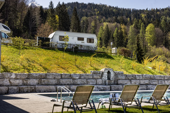 Pool an einem Frühlingstag mit Wohnwagen im Hintergrund